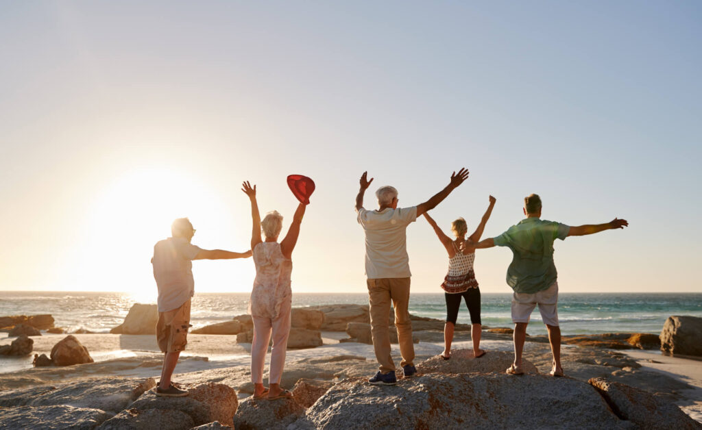 rear view of senior friends standing on rocks